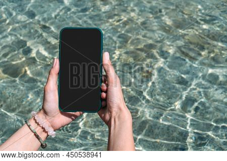 Smartphone Mockup In Woman's Hands On A Summer Day. Against The Backdrop Of Clear Water.