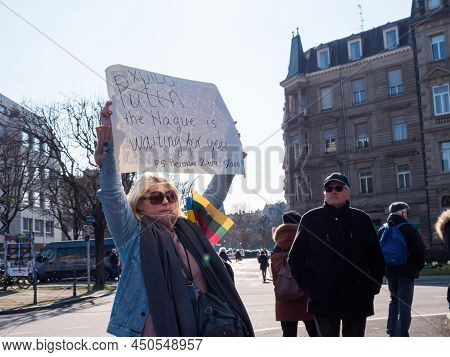 Strasbourg, France - Mar 6, 2022: Woman Holding Placard Putin The Hague Is Waiting For You In Front 