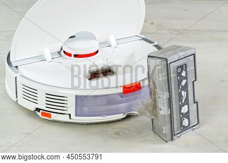 Robot Vacuum Cleaner Water Tank Removed And The Filter Lid Is Opened To Clean. Smart Cleaning And Wa