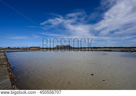 White Pond For The Extraction Of Salt. Blue Sky And Gorgeous Clouds Over An Artificial Reservoir. Ab