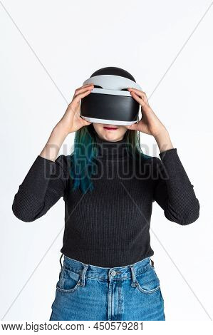 A Girl Puts On A Vr Helmet To Enter The Virtual Universe On A White Background. The Concept Of The V