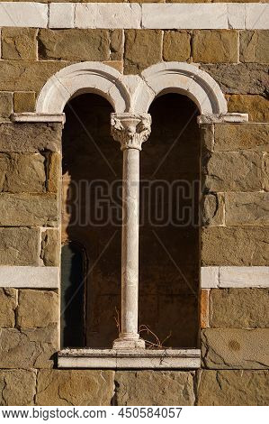 Medieval Architecture In Lucca. A Typical Bifora Tye Window With Central Column