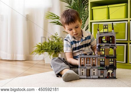 Khabarovsk, Russia, February 18, 2022. Baby Boy Plays With Spiderman Lego House At Childish Room