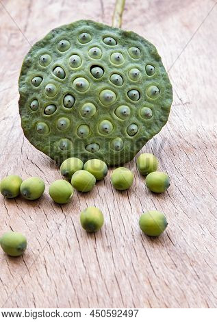 Fresh Green Lotus Seed Pods And Lotus Seeds Green On Old Wooden Board Background. Selective Focus.