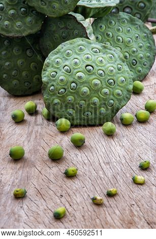 Fresh Green Lotus Seed Pods And Lotus Seeds Green On Old Wooden Board Background. Selective Focus.