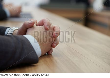 Hands Of An Elegant Man In A Business Suit On A Wooden Table. Participant Of Negotiations Or Meeting