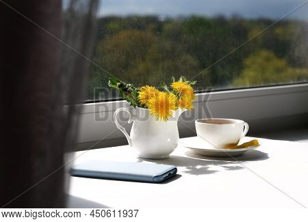 Cup Of Tea, Dandelion Flowers And Phone. Spring Morning.