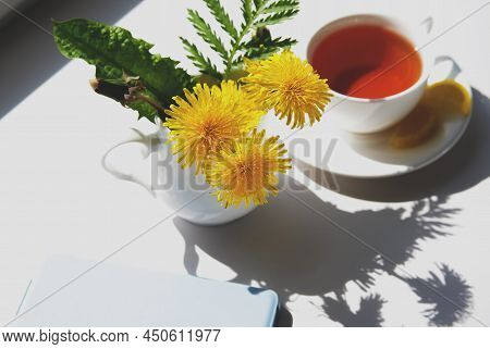 Cup Of Tea, Dandelion Flowers And Phone. Spring Morning.