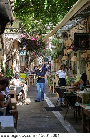 Rethymnon, Crete, Greece - Sept 18, 2021: The Narrow Street In Old Town Of Rethymnon  Where There Ar