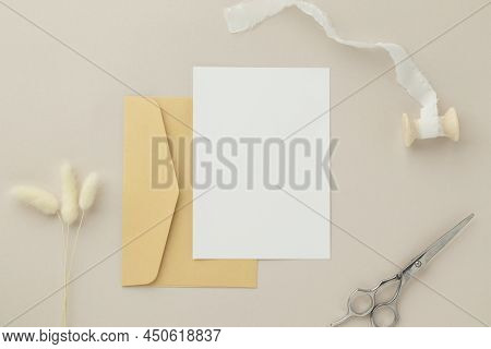 Blank Greeting Card Invitation Mockup 5x7 On Brown Envelope With Dried Flowers On Beige Background, 