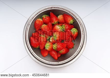 Fresh Strawberries In A Basket Over White Background