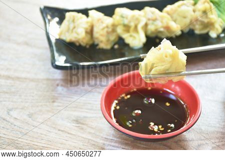 Steamed Chinese Dumpling Stuffed Mashed Pork Dipping Soy Sauce Picking By Chopsticks On Plate