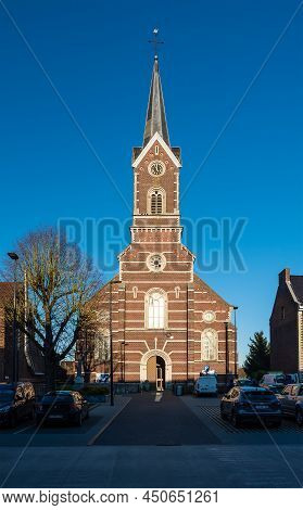 Wommersom, Flemish Brabant Region, Belgium 02 27 2022 - Catholic Church Over Blue Sky At The Main Vi
