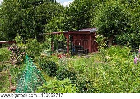 Uccle, Brussels - Belgium -  06  14 2019 - Wooden Garden House And Shed In A Kitchen Garden In The A