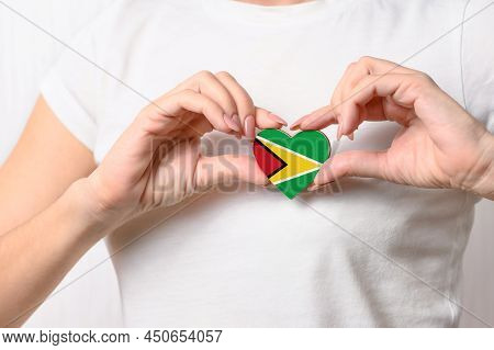 Flag Of Guyana In The Shape Of A Heart In The Hands Of A Girl. Love Guyana. Respect For The People O