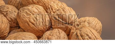 Ripe Walnuts On A Wooden Table.  Walnut Fresh Nuts Background Top View
