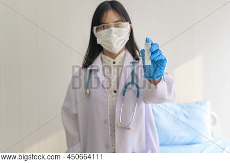 Young Female Doctor Holding Atk Kit In Hospital, Covid19 And Pandemic Concept