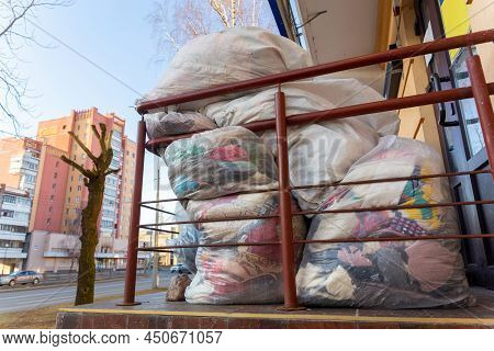 Used Clothes And Shoes In Plastic Bags. New Arrival Of The Goods In The Second-hand Store. Humanitar