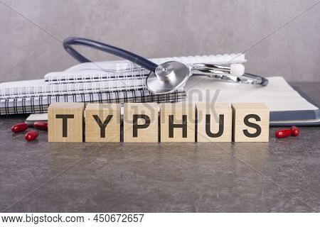 Typhus Text On Wooden Blocks, Medical Concept, Gray Background