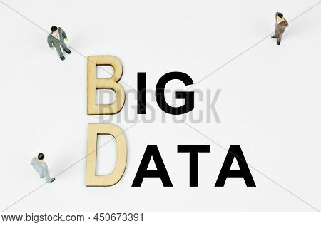 Economy And Business Concept. On A White Background, Figures Of Businessmen, Wooden Letters And The 