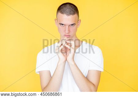Conspirator Man. Evil Plan. Face Expression. Angry Gloomy Guy In White T-shirt Holding Hands Togethe