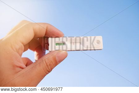 Own Hand Showing Covid-19 Negative Test Result With Sars Cov-2 Rapid Antigen Test Kit (atk) And Blue