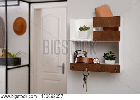 Hallway Interior With Stylish Accessories And Wooden Hanger For Keys On White Wall