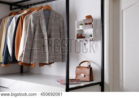 Hallway Interior With Stylish Furniture, Accessories And Wooden Hanger For Keys On White Wall