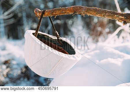 German Wehrmacht Infantry Soldiers White Helmet Hanging On Wooden Banch In Snow Winter Forest. World
