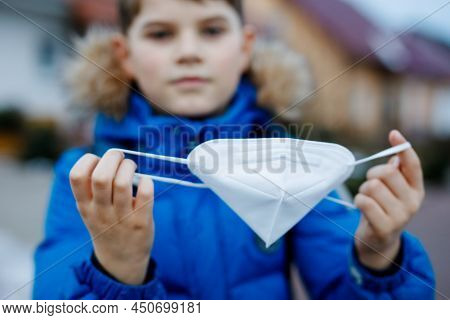 Kid Boy Wearing Ffp Medical Mask On The Way To School. Child Backpack Satchel. Schoolkid On Cold Aut