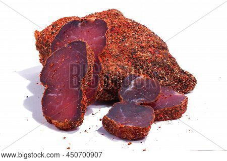 Juicy Delicious Slices Of Dried Meat (basturma), Sprinkled With Various Spices On A White Background