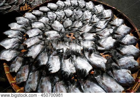 Salted Gourami Fish Lay On Basket In The Sun For Natural Drying. Top View. Flat Lay. Close-up. Selec