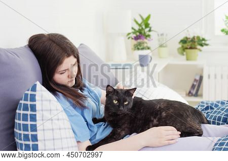 Happy Teen Girl With Black Cat In White Bedroom