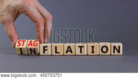Stagflation Or Inflation Symbol. Businessman Turns Cubes And Changes The Concept Word Inflation To S
