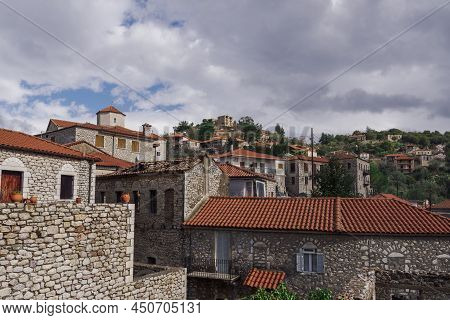 Greek Village With Traditional Stone Built Houses Against Sky With Clouds. Day View Of Historic Sett