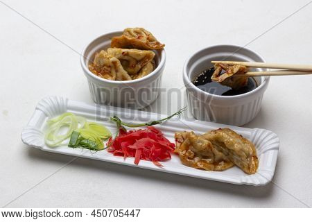 Pickled Ginger, Chopped Leeks And Gyoza On Plate. Gyoza Dumplings In Bowl. Gyoza Chopsticks In Bowl 