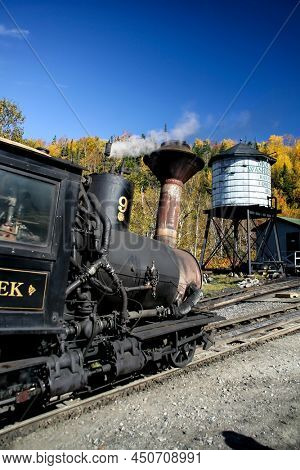 MOUNT WASHINGTON COG RAILWAY, BRETTON WOODS, NH - OCTOBER 6, 2007:  Mount Washington cog railway locomotive in foliage season with blue sky.