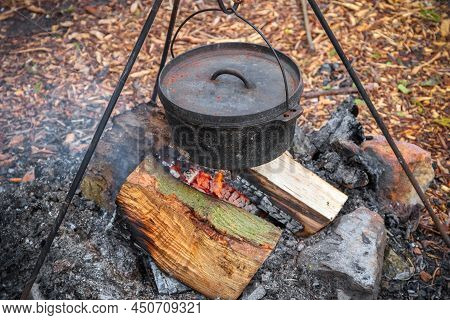 Cooking Food In A Cauldron Over Campfire In England