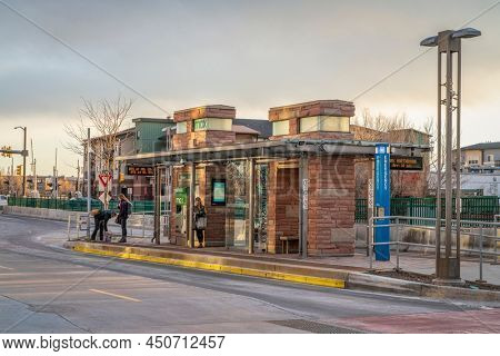 Fort Collins, CO, USA - March 8, 2022: Passengers are waiting at bus stop. MAX Bus Rapid Transit serves major activity and employment centers throughout Fort Collins including Midtown, CSU, Downtown.