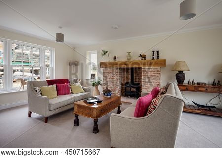 Suffolk, England - Feb 13 2018: Modern Furnished Luxury Living Room With Inglenook Firplace And Hear