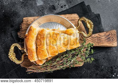 Traditional Feta Cheese Phyllo Pastry Pie In Rustic Skillet. Black Background. Top View