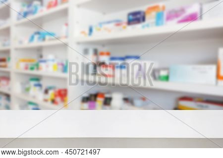 Pharmacy Drugstore Counter Table With Blur Abstract Backbround With Medicine And Healthcare Product 