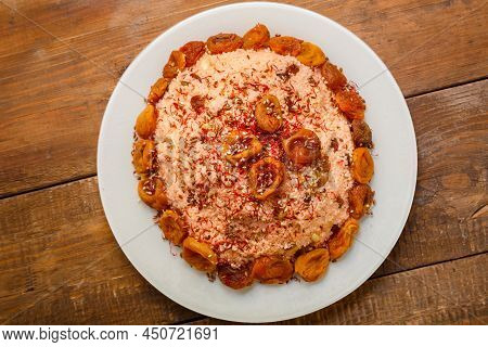 Masfouf From Couscous On Almond Milk With Dried Fruits And Nuts In A Plate On A Wooden Table. Horizo