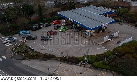 Wigan, Uk: March 10, 2022: Aerial View. Queuing Cars Waiting To Buy Fuel At A Tesco Petrol Filling S