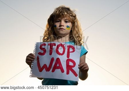 Kids Protest Against War. Portrait Blond Little Boy Calls To Stop War, Raises Banner With Inscriptio