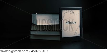 E Reader. Digital E Book, Library Reader Tablet With Books On Dark Background. Online Education Cour