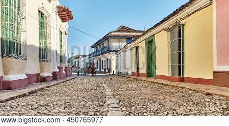 Trinidad, Cuba - February 12, 2022: Cobblestone Street In Colonial Old Town. Cabman On Horse-drawn C