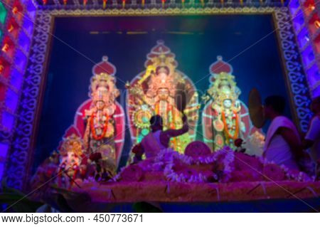 Blurred Image Of Goddess Durga Is Being Worshipped By Hindu Priest With Chamor. Vog, The Holy Food I