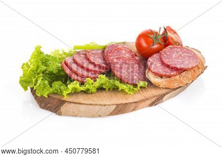 Pork Salami Slices On A Wooden Board