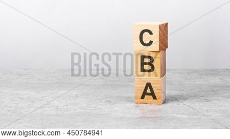 Wooden Cube On A White Table With Text Cba. Concept Of Business, Financial, Investment, Economy. Cop